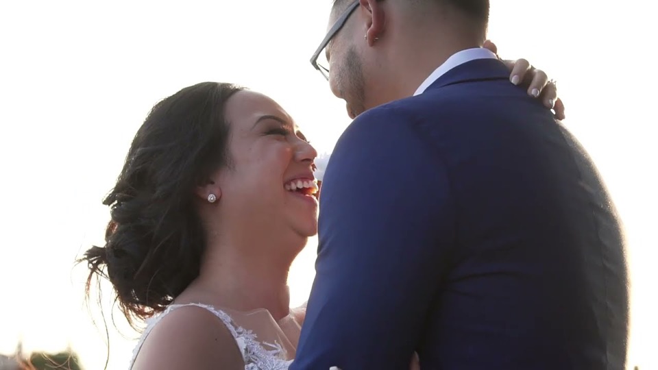 Anne laughing in Ed’s arms in warm light
